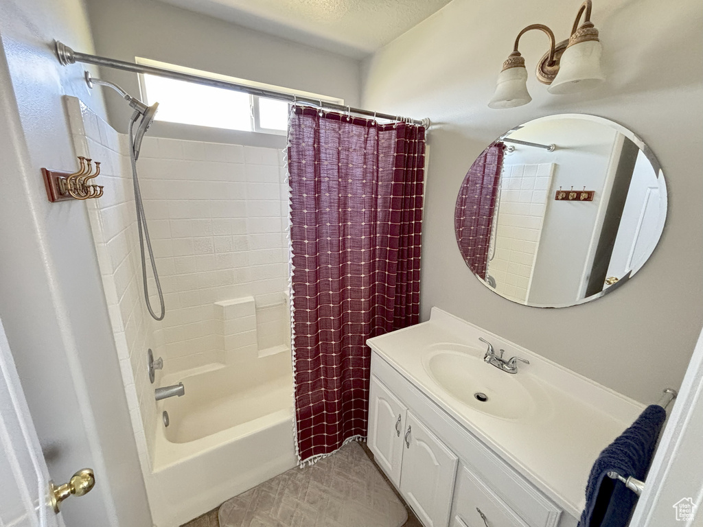 Full bath with shower / bath combination with curtain and vanity