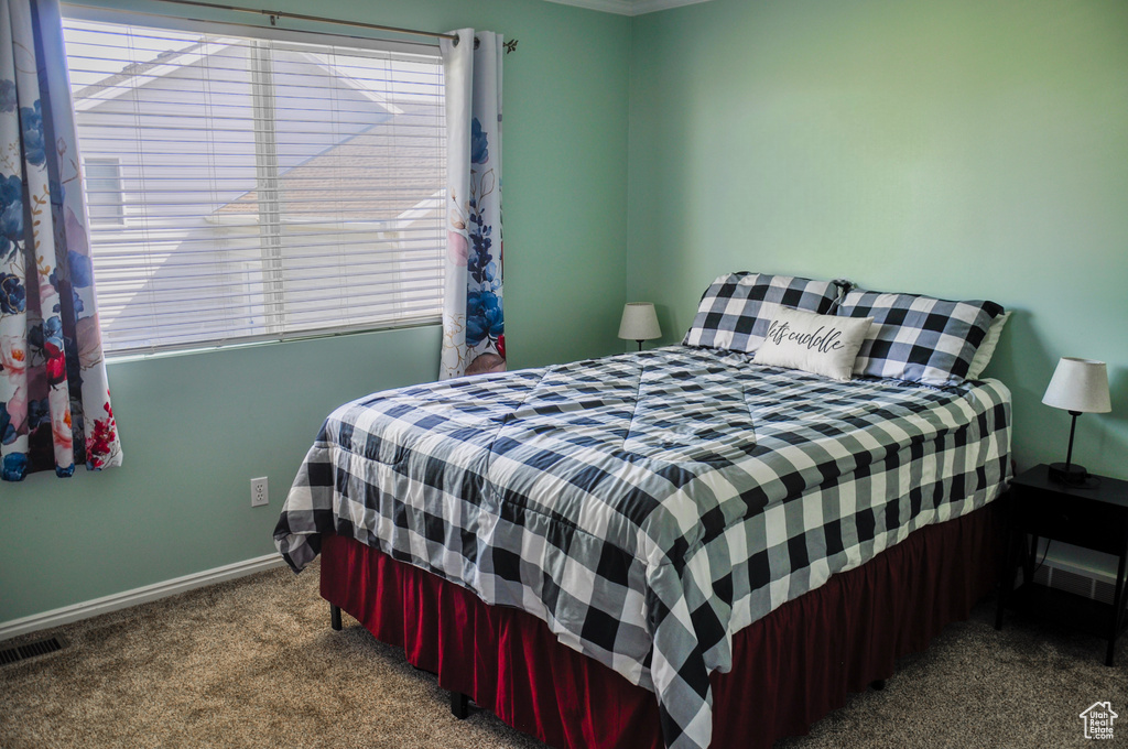 Carpeted bedroom with baseboards