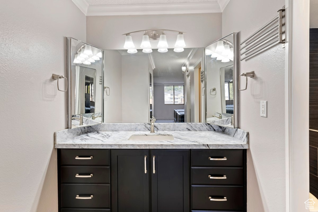 Bathroom featuring vanity and ornamental molding
