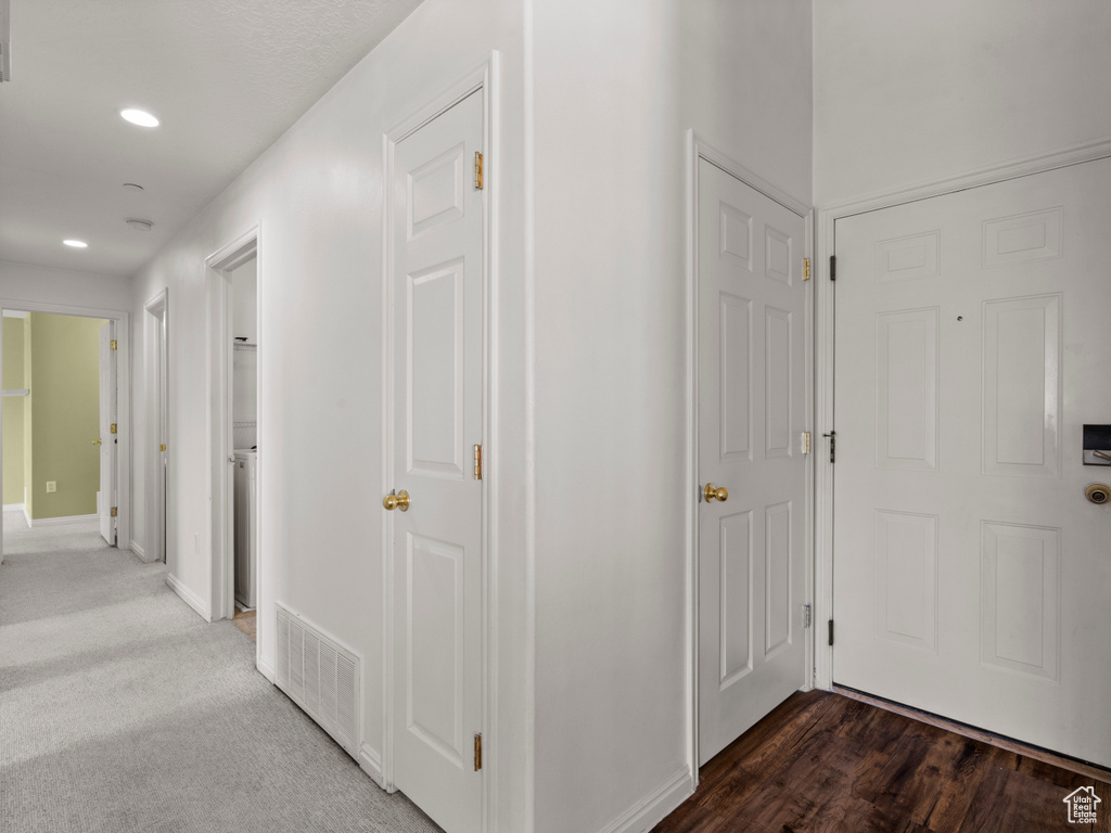 Hallway featuring recessed lighting and baseboards