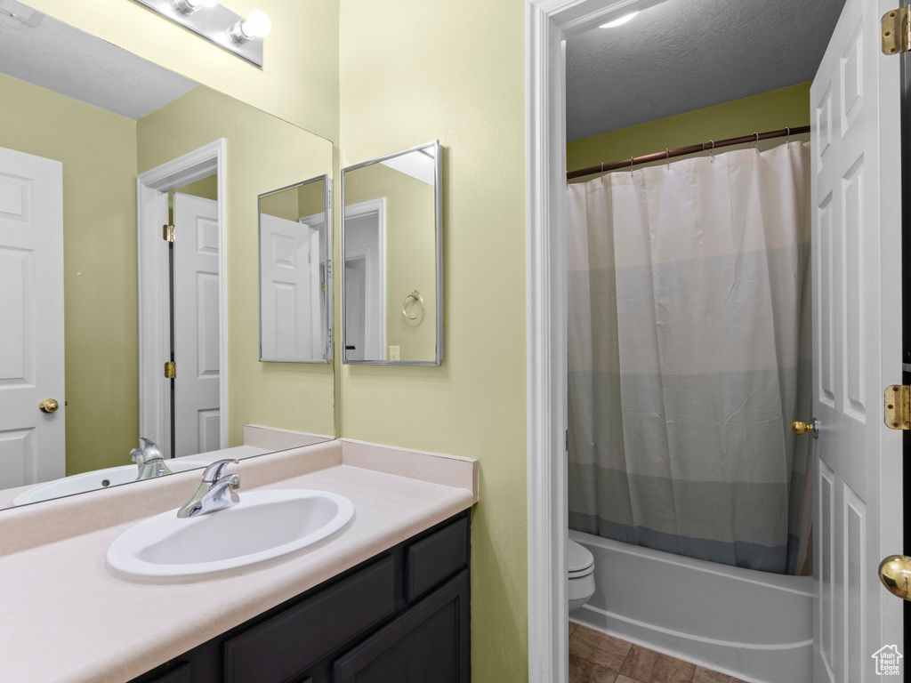 Bathroom featuring vanity and shower / bath combination with curtain