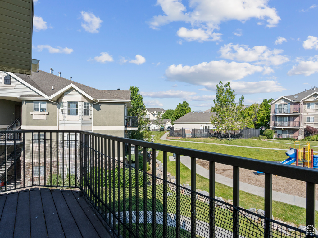Wooden deck featuring a residential view and a playground