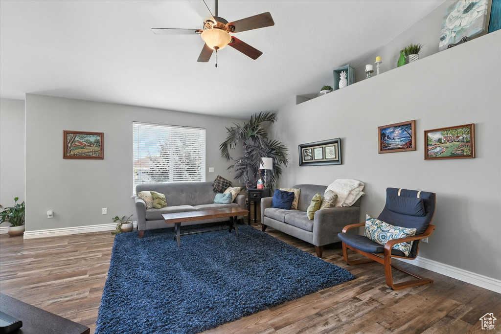 Living area featuring wood finished floors and ceiling fan