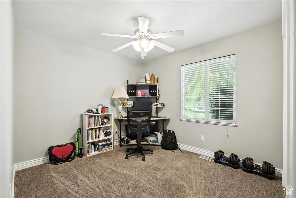Home office featuring carpet flooring and a ceiling fan