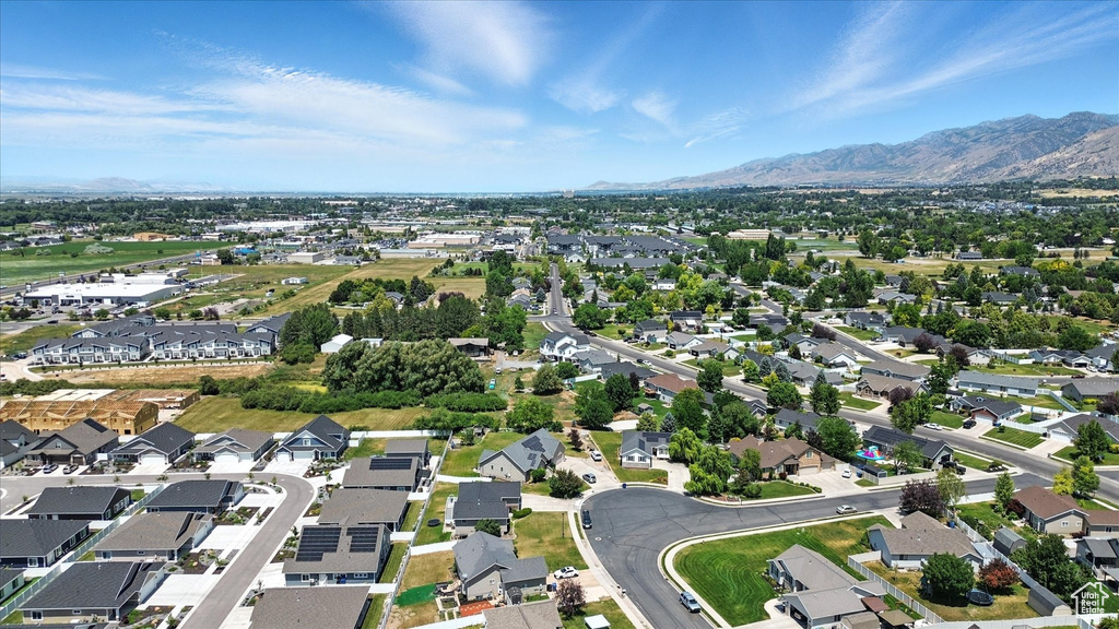 Aerial view of property's location with nearby suburban area and a mountain backdrop