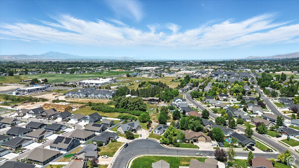 View of property location featuring mountains and nearby suburban area
