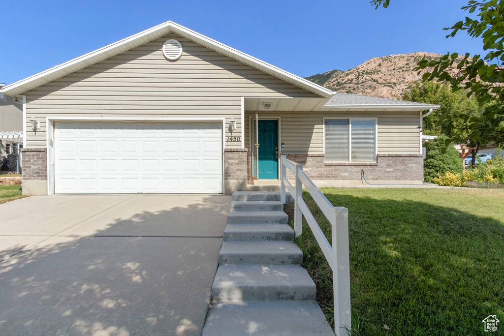 Ranch-style house featuring brick siding, concrete driveway, and a garage