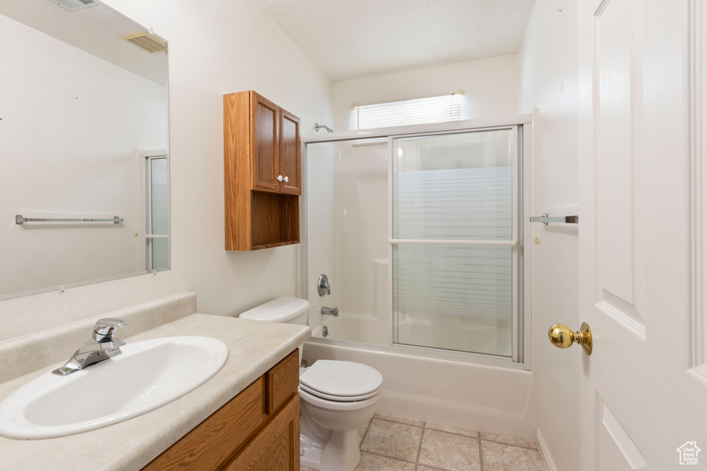 Full bathroom featuring vanity and enclosed tub / shower combo
