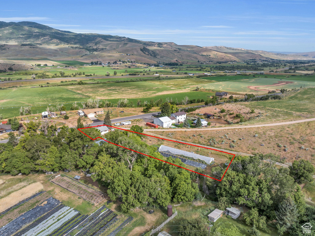 Overview of rural landscape featuring property boundaries highlighted and mountains