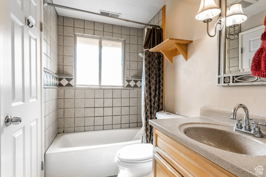 Bathroom with vanity and shower / bath combination with curtain