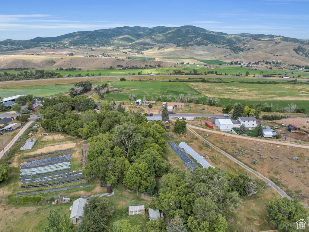 Aerial overview of property's location featuring rural landscape and a mountainous background