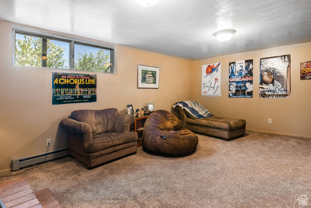 Living room featuring carpet floors and a baseboard radiator
