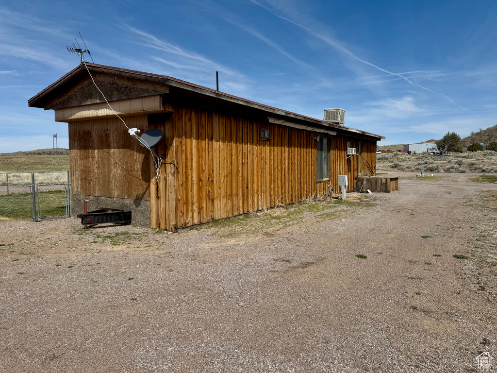 View of property exterior featuring a cooling unit