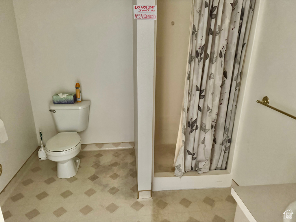 Full bath with tile patterned floors, a shower stall, and vanity
