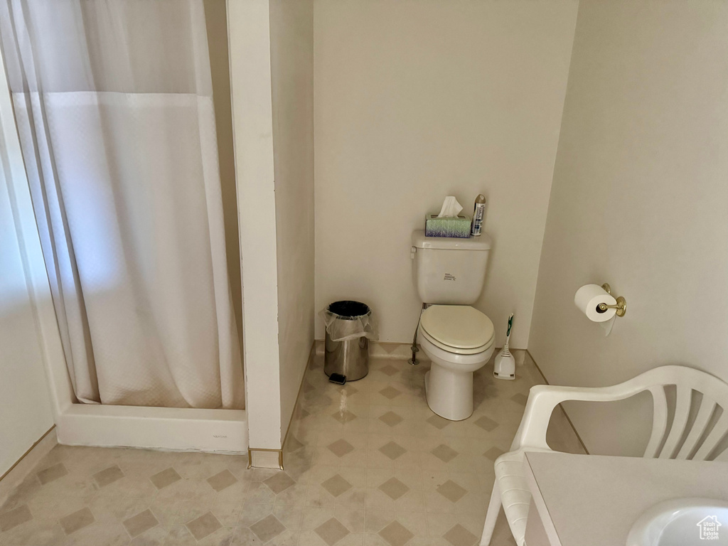 Bathroom with tile patterned floors and a shower stall