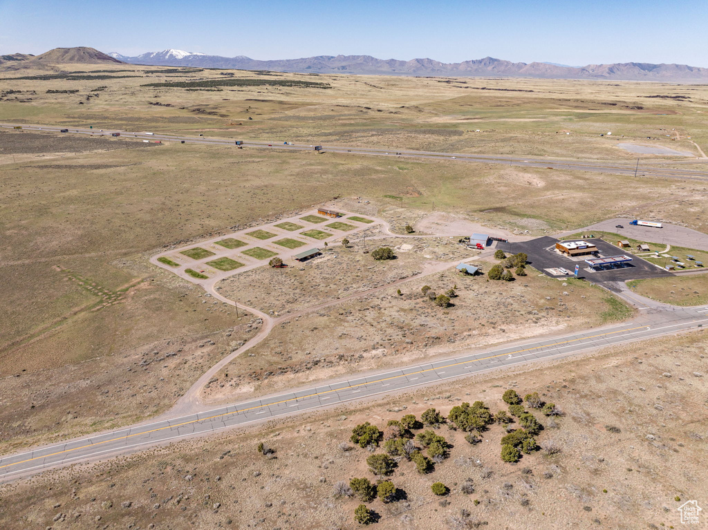 View of rural area with a mountain backdrop and a desert landscape