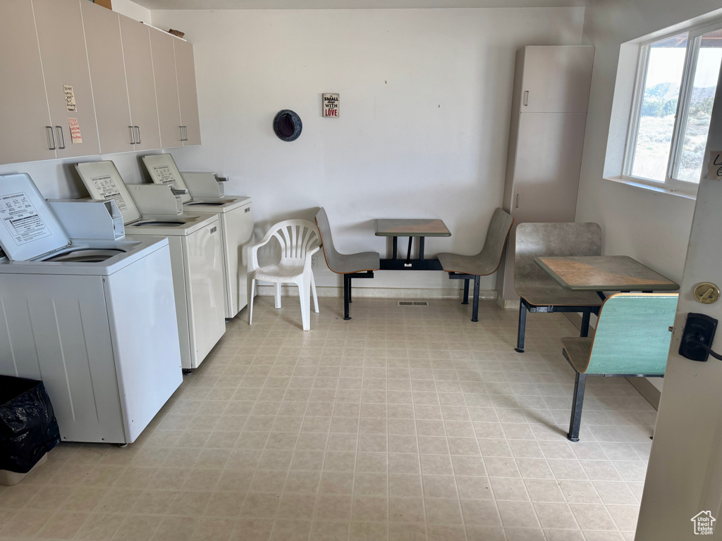 Shared laundry room featuring washer and dryer and light flooring