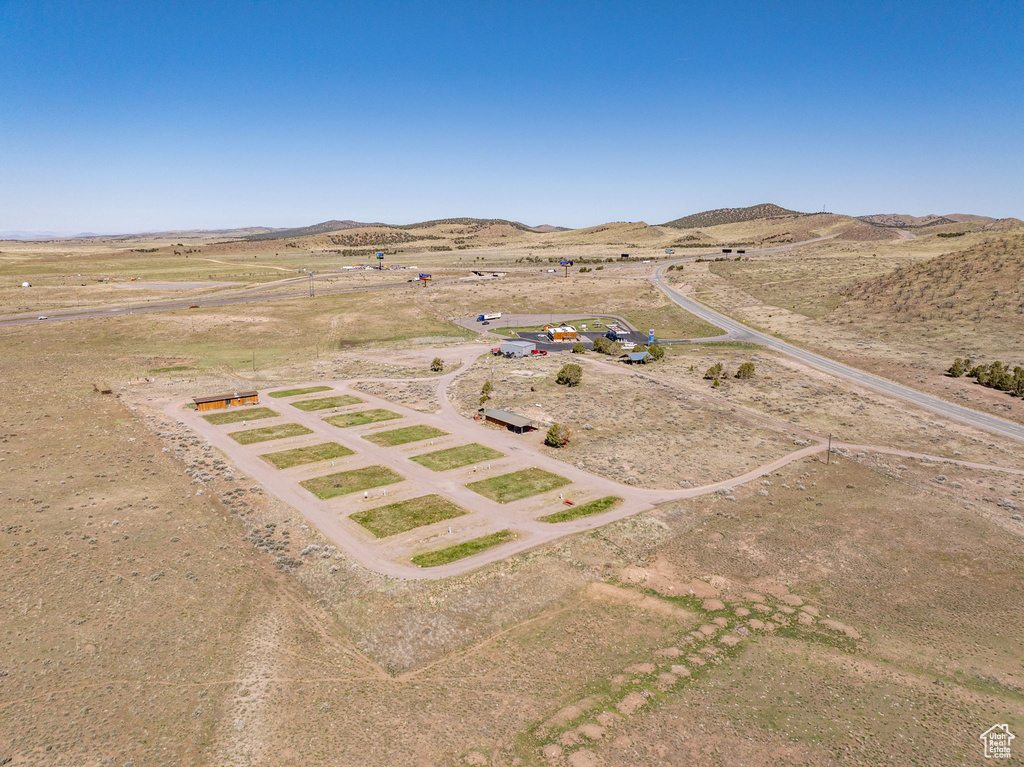 Aerial view of sparsely populated area featuring a mountainous background and a desert landscape