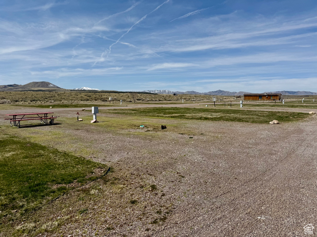 View of yard with a mountain view and a rural view