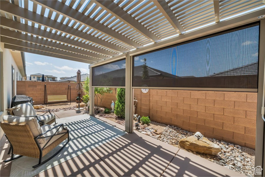 Fenced backyard featuring a patio and a pergola