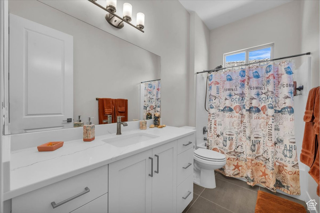 Bathroom featuring vanity, tile patterned floors, and a shower with shower curtain