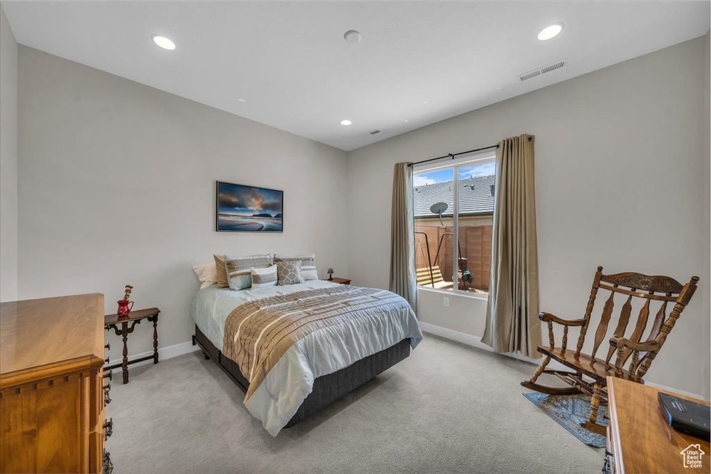 Bedroom featuring light colored carpet and recessed lighting