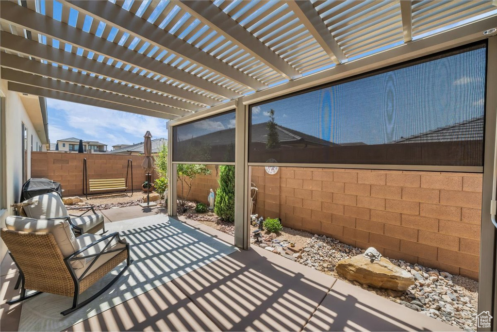Fenced backyard with a patio area and a pergola
