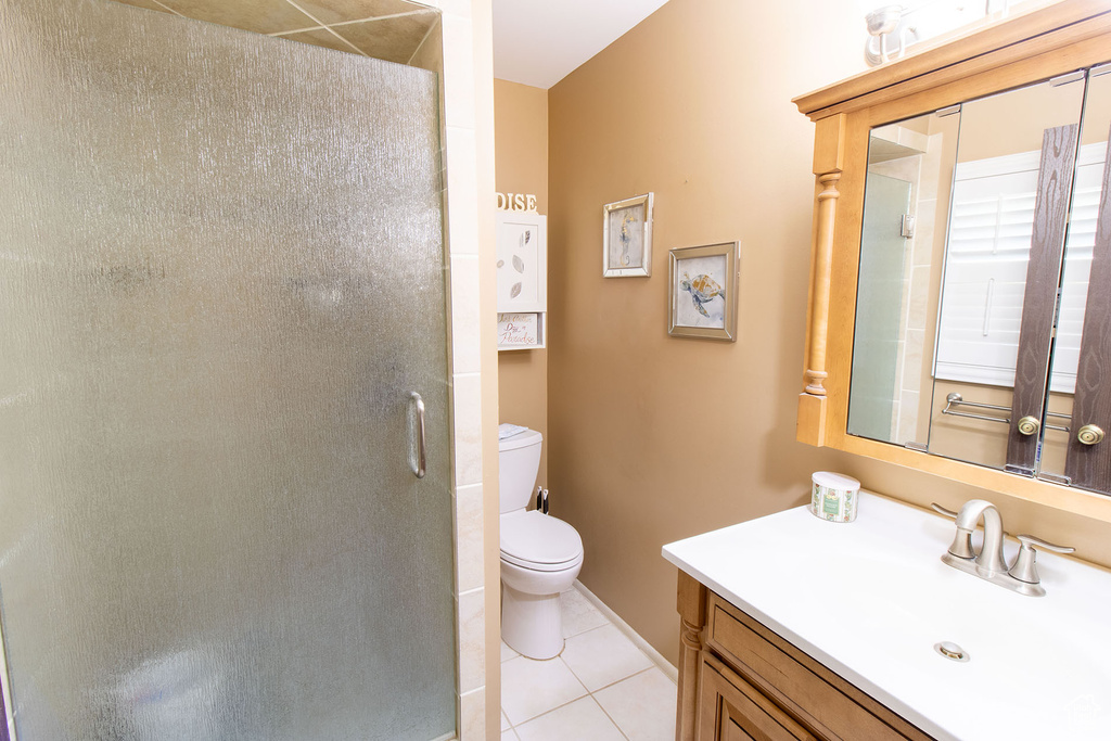 Bathroom featuring vanity, tile patterned flooring, and a shower stall
