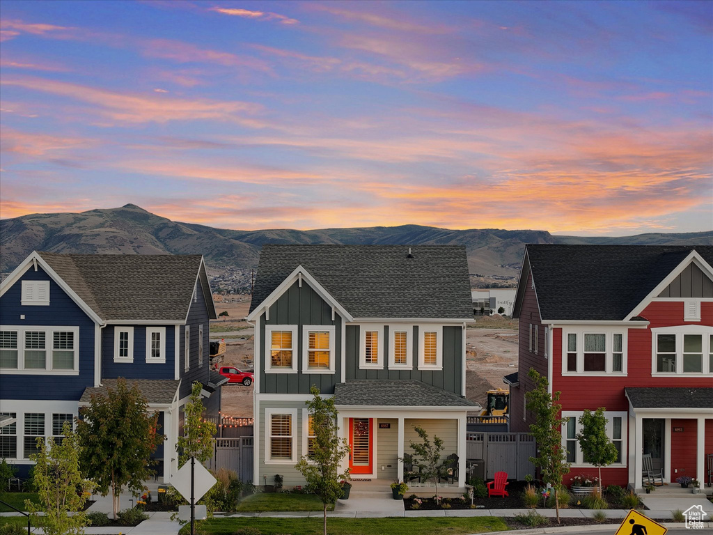 View of front of home with a mountain view and board and batten siding