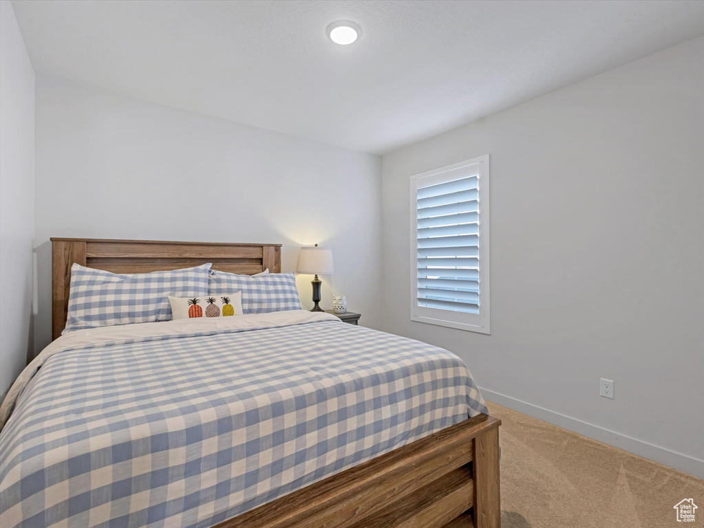 Carpeted bedroom with baseboards