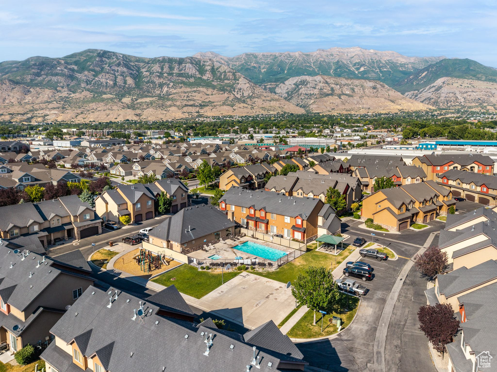 Aerial view of property's location featuring a mountain backdrop and nearby suburban area