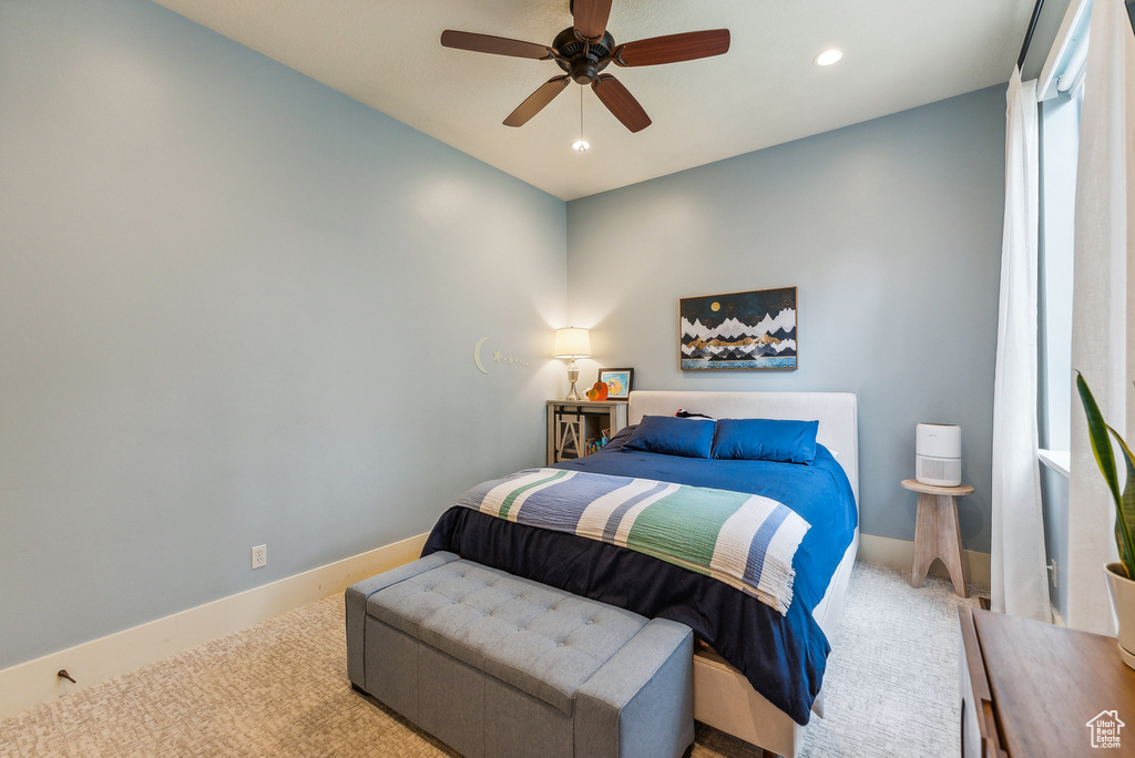 Carpeted bedroom featuring recessed lighting and a ceiling fan