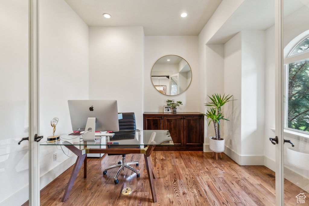 Office area with french doors, light wood-type flooring, and recessed lighting