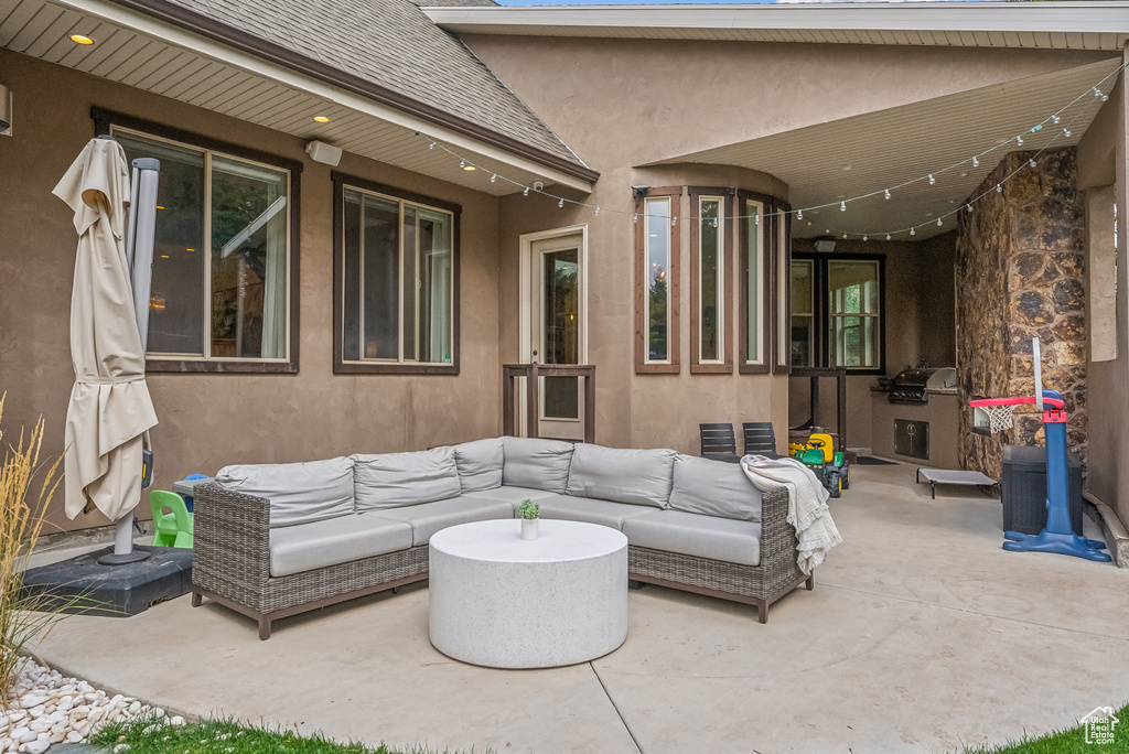 View of patio with an outdoor hangout area and area for grilling