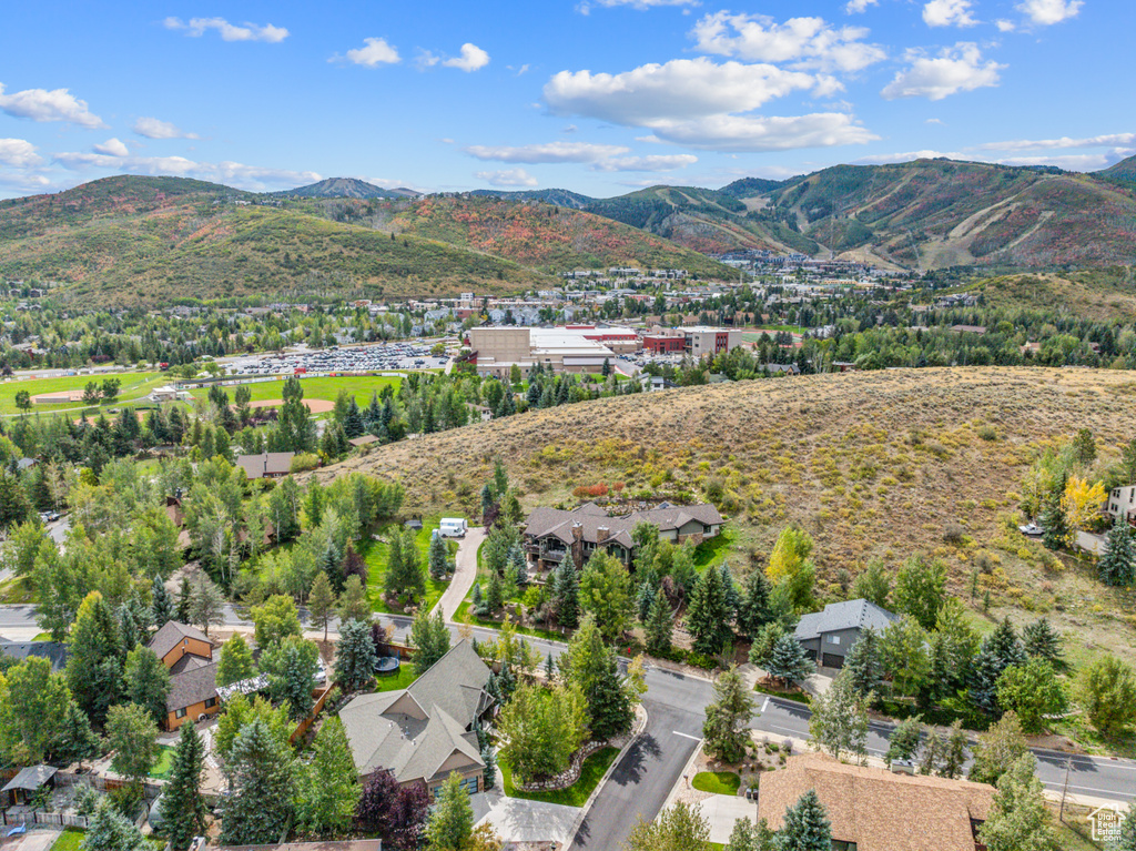 Aerial view of property and surrounding area with a mountain backdrop