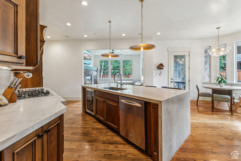 Kitchen featuring appliances with stainless steel finishes, wine cooler, dark wood-style flooring, recessed lighting, and light countertops