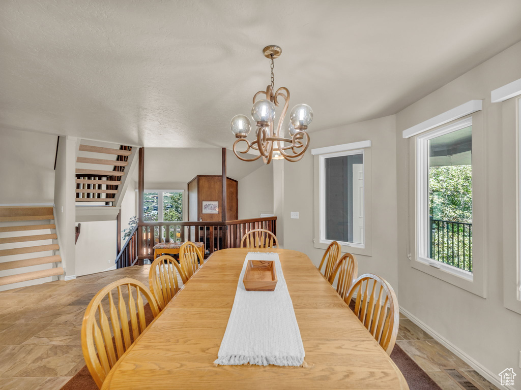 Dining area featuring a chandelier and baseboards