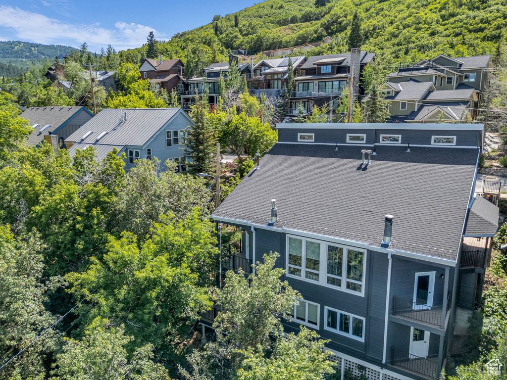 Aerial perspective of suburban area featuring a heavily wooded area