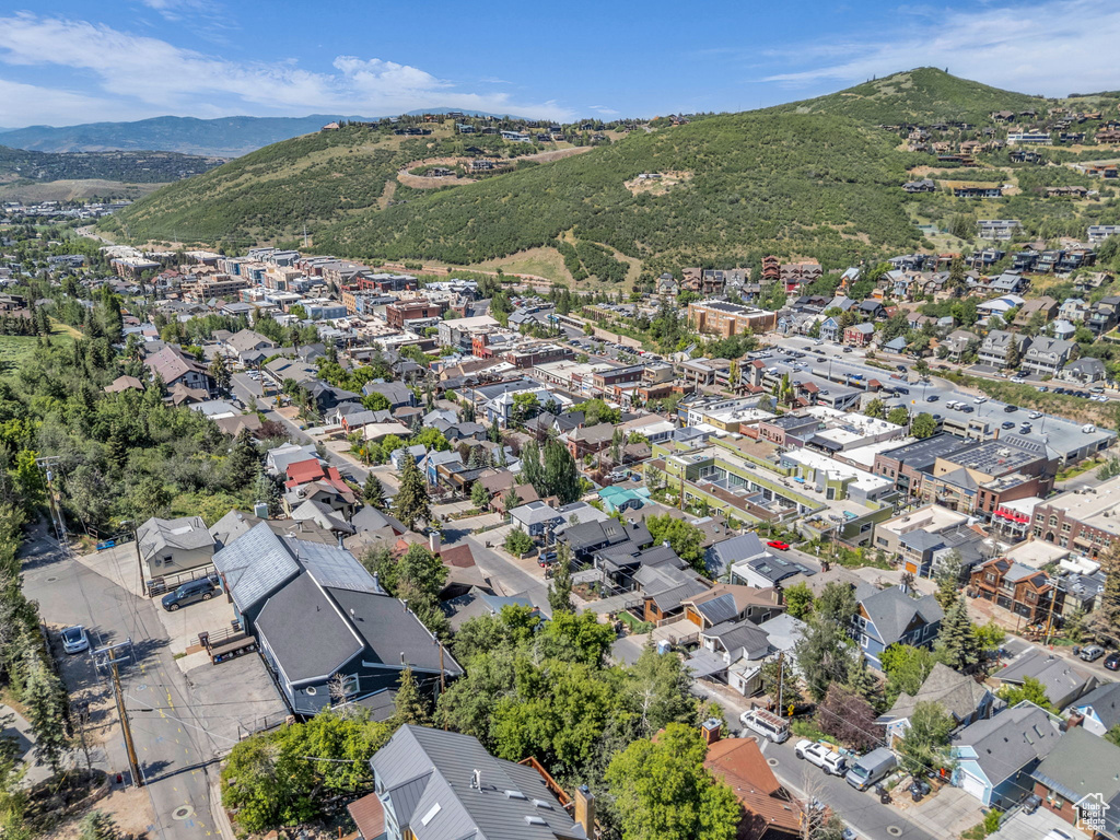 Aerial view of property and surrounding area with a mountain backdrop