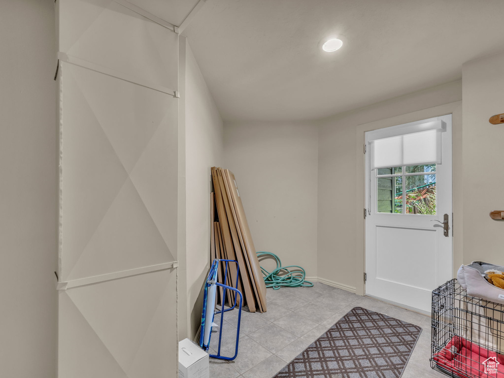 Doorway to outside featuring tile patterned floors