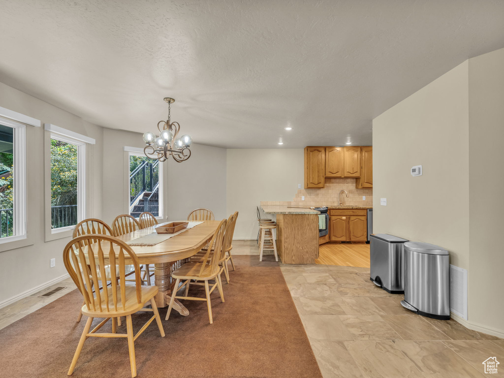 Dining space featuring a chandelier and recessed lighting