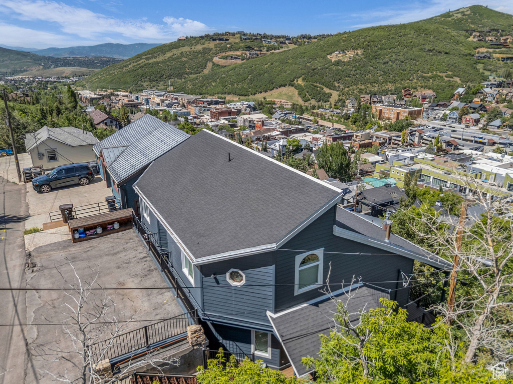 Aerial view of property and surrounding area with a mountain backdrop
