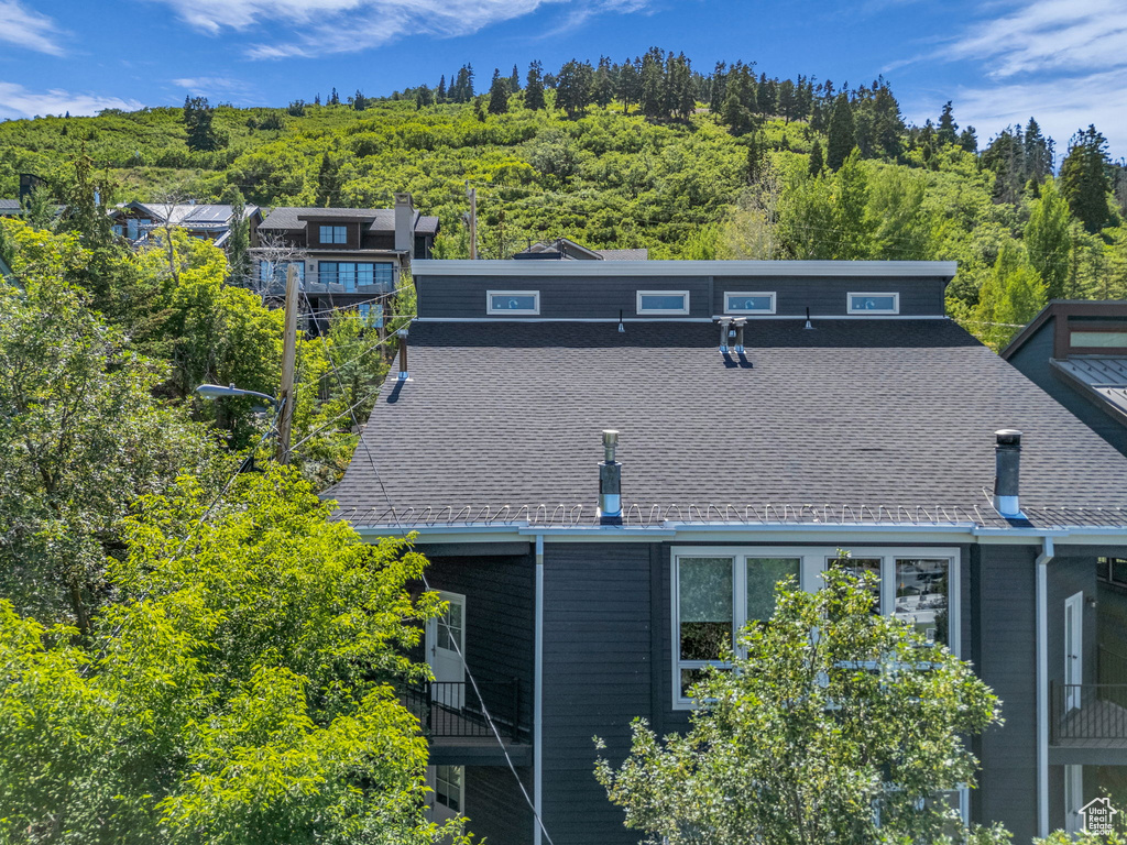 Back of property featuring a forest view