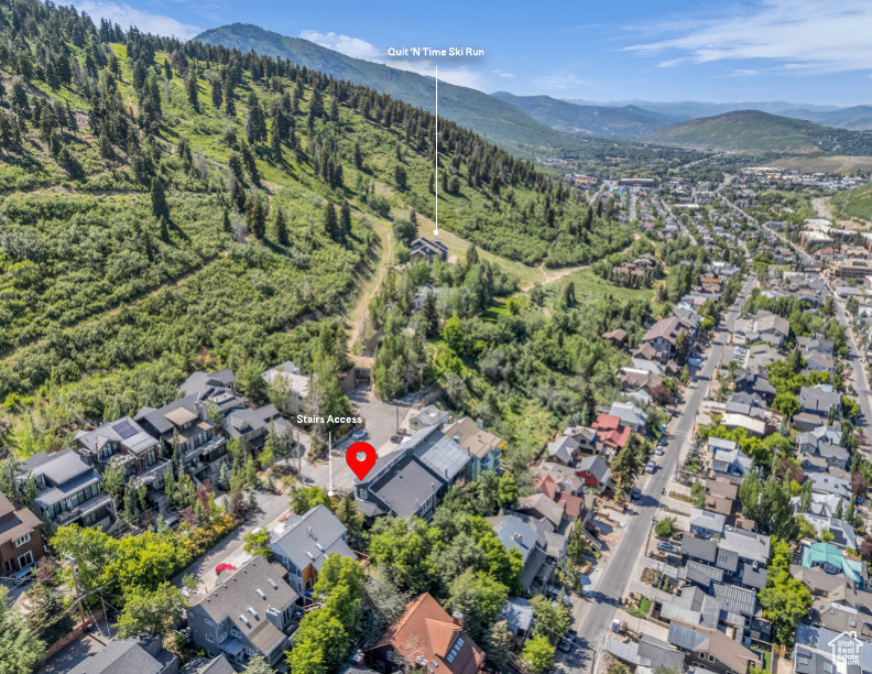 View of property location featuring a mountainous background and nearby suburban area