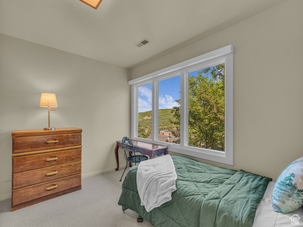 Bedroom featuring carpet floors and baseboards