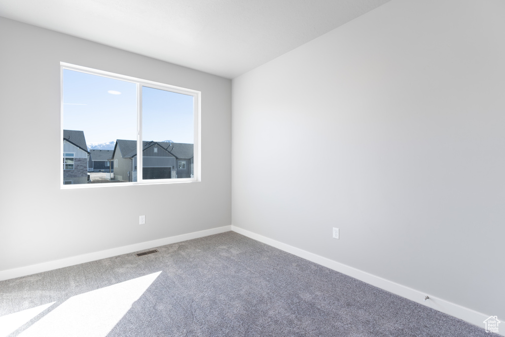 Unfurnished room with carpet and baseboards