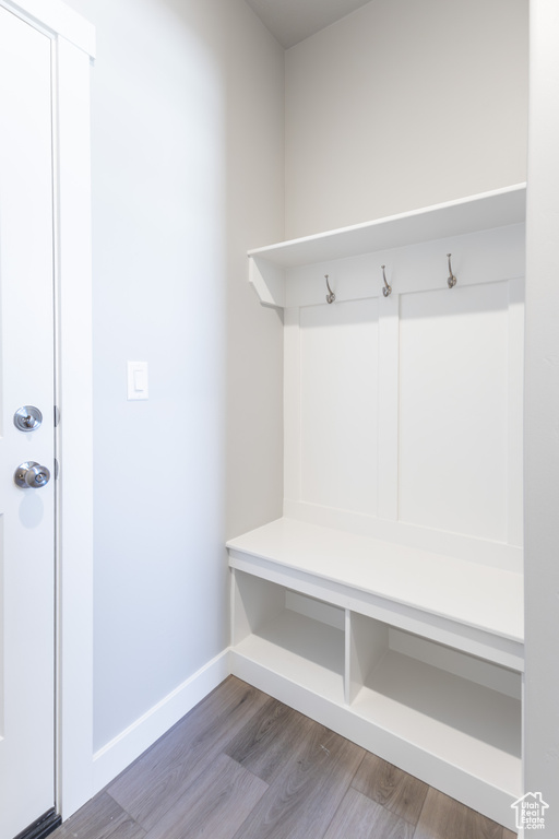 Mudroom featuring wood finished floors and baseboards