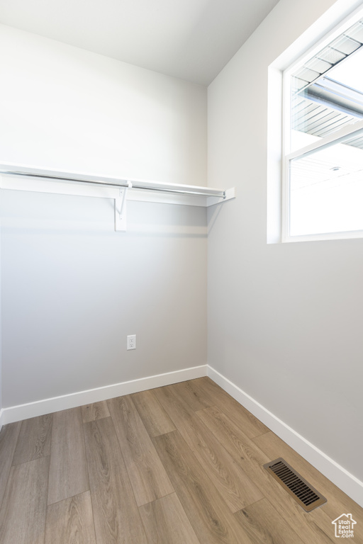 Walk in closet featuring wood finished floors