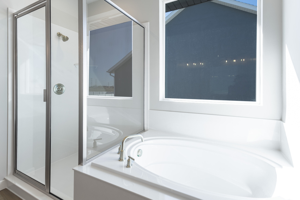 Bathroom with a shower stall and a garden tub
