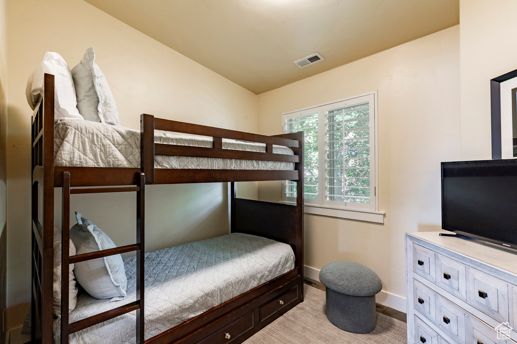 Bedroom with baseboards and lofted ceiling